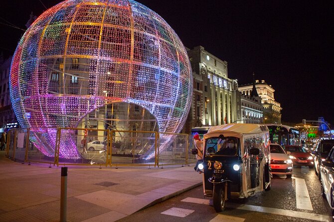 Christmas Lights Tour of Madrid in Eco Tuk Tuk Private - Puerta de Alcalá and the grand eastern entrance