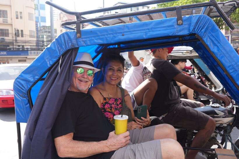Manila: Guided Tuk Tuk Ride - Walking through working neighborhoods