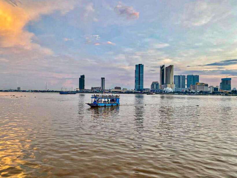 Phnom Penh: Mekong River Sunset Cruise and Tuk Tuk Ride - Boarding the traditional wooden boat