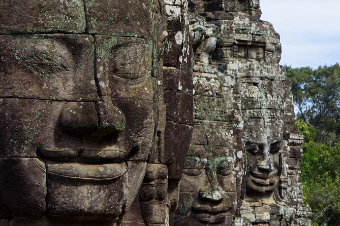 The Angkor Temples from Sunrise by Tuk Tuk - Bayon puts giant faces at the center of the day