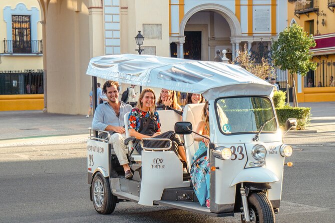 Tour Welcome Seville with Local Guide in Eco Tuk Tuk Private - The riverfront: Torre del Oro and Maestranza